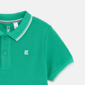 Boy's green short-sleeve polo shirt.
